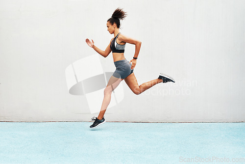 Image of Fitness, action and jump of running woman for exercise, cardio training or workout outdoors. Fit, active or sport female person or runner in sports motivation for power run or jumping on mockup space