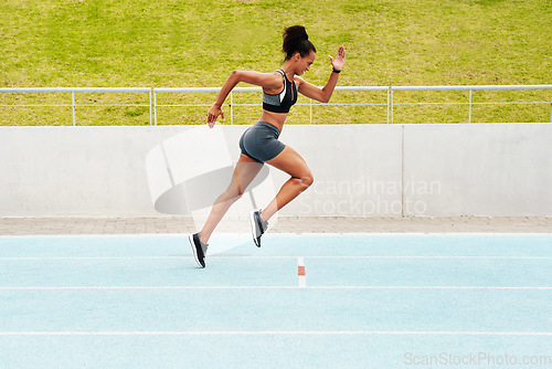 Image of Woman, cardio and running on track in training, physical exercise or workout on stadium. Active, fit or sporty female person, athlete or runner in sports run, race or competition for healthy wellness