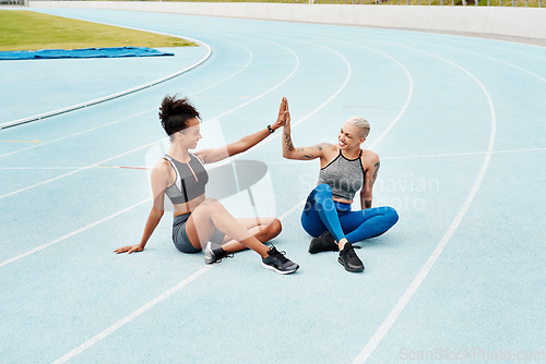 Image of Woman, team and high five on stadium track for running, workout or exercise together for goal outdoors. Sports women touching hands for support, fitness or friends in motivation, teamwork or training