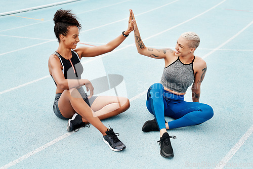 Image of Happy woman, team and high five on stadium track for running, workout or exercise goals together. Sports women touching hands in support, fitness or friends for motivation, unity or teamwork training