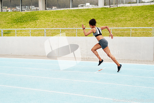 Image of Woman, fitness and running on track for cardio training, exercise or workout on the stadium. Active or sporty female person, athlete or runner in sports run, race or competition for healthy wellness