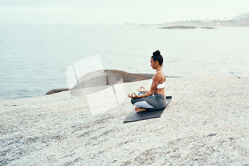 Image of Yoga, meditation and woman on a beach with lotus pose, wellness and fitness. Pilates, sea and female person on sand with peace in nature feeling relax and calm with spiritual and holistic mockup