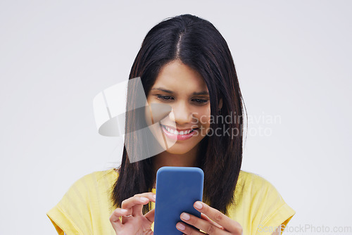 Image of Typing, smile and woman with a cellphone, connection and network against a white studio background. Female person, girl or model with a smartphone, online reading or search internet with website info
