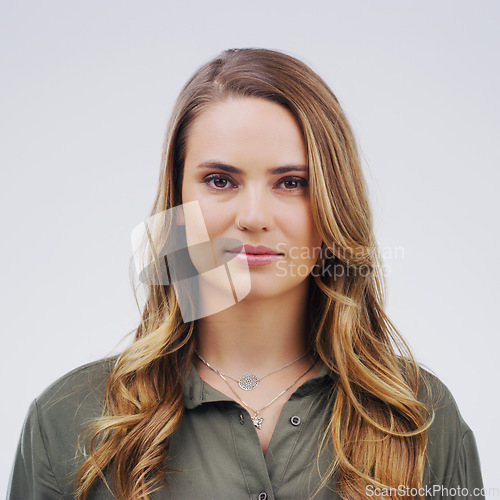 Image of Face, serious student and a woman in studio with confidence, natural beauty and front. Portrait of a young female model from London isolated on a white background with concentration and focus