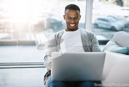 Image of Laptop, man and working on home sofa or remote learning, elearning or online class, internet and email communication. African male, happy on computer and study, research and work in living room