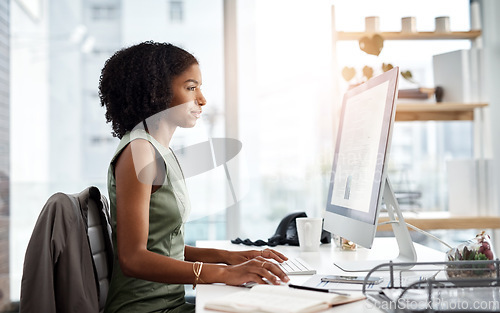 Image of Computer, typing and business woman in office for online research, copywriting and editing for job website. Young african person, editor or journalist on desktop pc or monitor for article or report