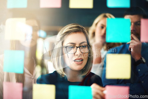 Image of Woman, ideas and brainstorming with team on glass for schedule, mindmap and planning goals, agenda and timeline. Face of manager, collaboration and sticky note for innovation, training and target