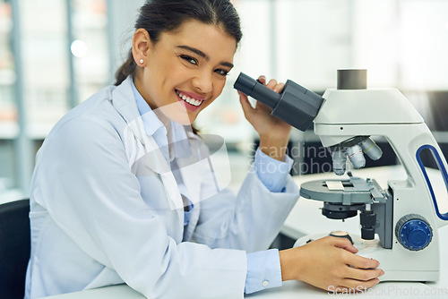 Image of Scientist, portrait and smile of woman with microscope in laboratory for medical research. Face, science and female doctor with lens equipment for sample analysis, particle test and lab experiment.