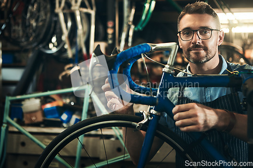 Image of Portrait, serious and repair man in bicycle shop working in store and cycling workshop. Face, bike mechanic and confident male person, professional and mature technician from Canada with glasses.