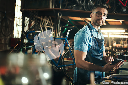 Image of Portrait, calculator and repair man in bicycle shop working in store for sales. Face, bike mechanic and serious male professional from Canada with glasses, pride and mature in cycling workshop.