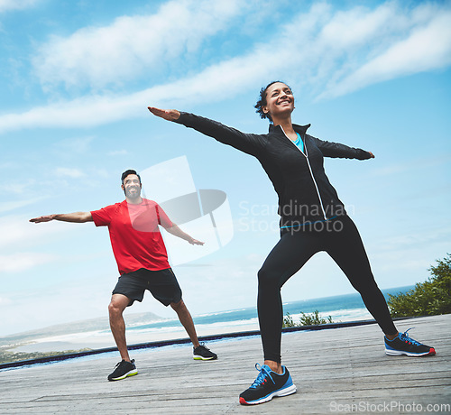 Image of Fitness, health and couple doing outdoor pilates stretching together for body balance exercise. Happy, smile and young man and woman doing a yoga warm up workout or challenge for health in nature.