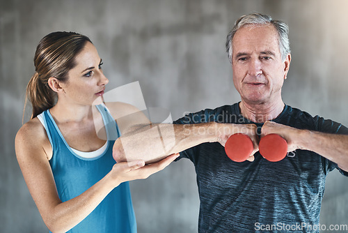 Image of Helping, dumbbell and fitness with old man and personal trainer for support, health and physiotherapy. Training, weightlifting and coaching with senior patient and female trainer for elderly workout