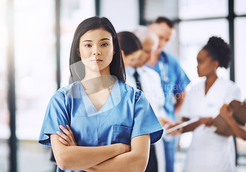 Image of Healthcare, confidence and portrait of nurse with arms crossed in hospital for support, career in medicine and care. Health, clinic and Asian woman caregiver, serious face of medical professional.