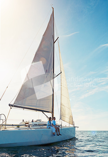 Image of Ocean, travel and boat in the outdoor with couple for adventure on luxury sea journey. Together, water and transport on yacht with rich lifestyle on a cruise in summer for a holiday with waves.