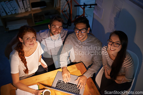 Image of Portrait, teamwork and night with developer group on a laptop, working overtime for planning, problem solving or web design from above. Meeting, collaboration and IT colleagues at work in the evening