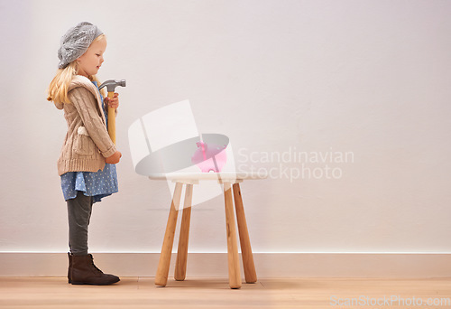 Image of Waiting, piggy bank and a girl with a hammer for money, savings and finance in a house. Investment, mockup space and little child standing with a tool to break a cash box for coins, banking or wealth