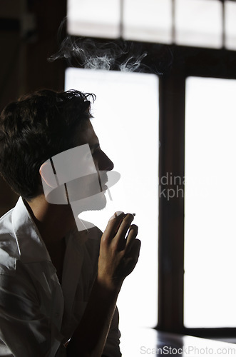 Image of Smoking, man and thinking in pub with cigarette or male model or vapor customer and smoker unhealthy on bokeh. Habit, addiction and male person with tobacco or in thought or relaxing and in a club