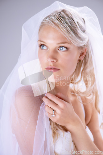 Image of Thinking, veil and woman bride in wedding dress or with bridal makeup and cosmetics on lace in white studio background. Doubt, marriage and female person dream about serious and natural love