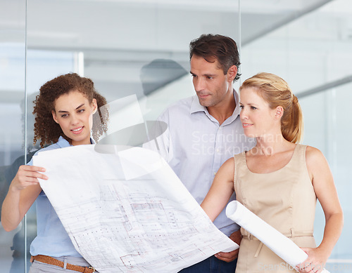 Image of Architect team, blueprint and planning in construction, meeting or collaboration at office. Group or business people looking at document, paperwork or floor plan for architecture project at workplace