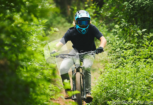 Image of Mountain bike, man and cycling in forest for competition, freedom and off road adventure on path. Athlete, extreme sports and bicycle for action, cardio race and adrenaline in nature, park and trail