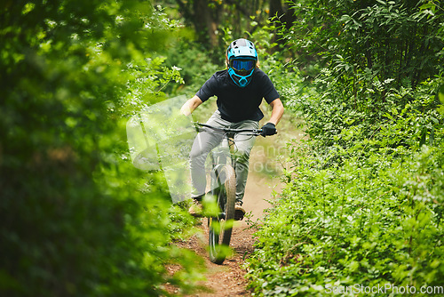 Image of Man, mountain bike and extreme sports in forest for adventure, speed and power in park. Athlete, freedom and bicycle race for outdoor action, off road fitness and gear of cardio competition in nature