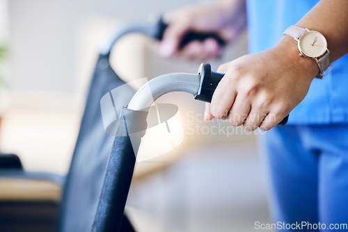 Image of Woman, hands and closeup of wheelchair handles in nursing home for rehabilitation, help and care. Nurse, helping hand and support for person with disability in hospital, clinic or home for healthcare