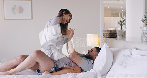 Image of Couple, love and playful in bed, room and romance of special moment, relaxing and bonding together at home. Young man, woman and laughing for happy relationship, fun honeymoon and care in the morning