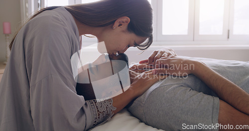 Image of Couple, love and kiss in bed, room and romance of intimacy, special moment and bonding together at home. Young man, woman and kissing partner for happy relationship, honeymoon and care in the morning