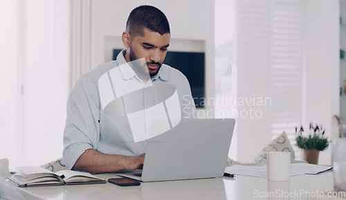 Image of Man, remote work and typing at laptop in home for digital planning, online research and information at table. Male freelancer working on computer technology, internet and reading email for budget