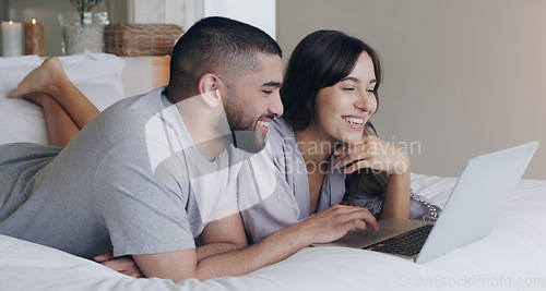 Image of Happy, couple and relax with laptop in bedroom for watching subscription movies, download media and online shopping. Man, woman and computer tech for streaming, internet or happiness together at home