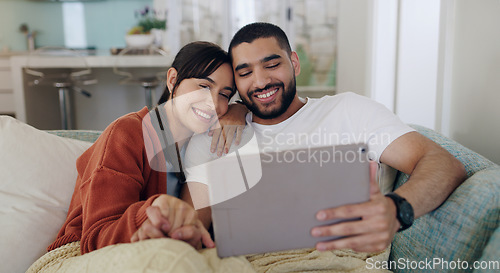 Image of Tablet, happy couple and relax on couch in home for social media, online entertainment and love. Young man, woman and digital technology for web subscription, streaming movie and network connection