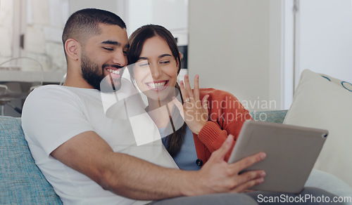 Image of Engagement, announcement and a couple on a video call from a sofa in the living room of their home together. Smile, proud or excited with a happy man and woman sharing good news about their marriage