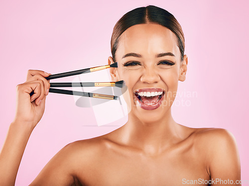 Image of Happy woman, portrait and makeup brushes for beauty cosmetics against a pink studio background. Excited female person with cosmetic tools or equipment for grooming, skin products or facial treatment