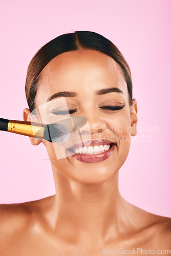 Image of Happy woman, face and makeup brush for beauty cosmetics against a pink studio background. Female person, smile and brushing with cosmetic tool or equipment for grooming, applying or facial treatment