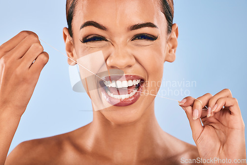 Image of Happy woman, portrait and flossing teeth in dental, clean hygiene or healthcare against a studio background. Female person or model with smile in tooth whitening, floss or oral, gum or mouth cleaning