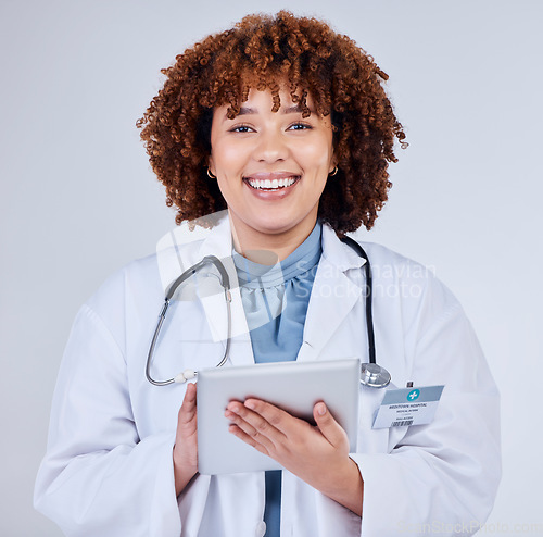 Image of Tablet, doctor portrait and woman isolated on a white background of happy healthcare research or telehealth services. Face of african medical person typing on digital tech and paperless app in studio