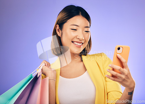 Image of Asian woman, selfie and shopping bag in studio with smile for deal, sale or discount by backdrop. Japanese influencer girl, retail and happy with social media, contact and luxury by purple background