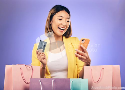 Image of Japanese woman, credit card and shopping bag in studio with smile for deal, sale or discount with fintech. Gen z asian girl, retail and happy with banking, budget or luxury gift by purple background