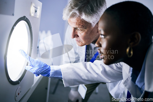 Image of Science, autoclave and lab with man, medicine and black woman with check for medical research. Scientist teamwork, diversity and smile together for pharmaceutical innovation in laboratory with mentor