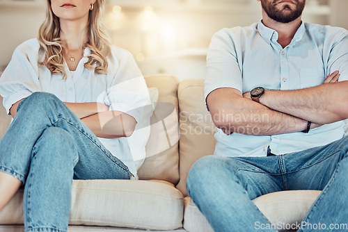 Image of Couple, arms crossed and argument on sofa, home and breakup in divorce, anger and problems. Closeup of angry man, woman and ignoring partner in fight, conflict and frustrated for relationship crisis