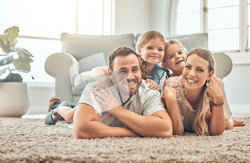 Image of Portrait of mother, father and children on living room floor for bonding, quality time and playing together. Happy family, smile and mom and dad with girls for care, love and relax at home on weekend