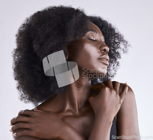 Image of African woman, beauty and skincare with relax and afro hair in a studio with dermatology. Wellness, skin care and natural cosmetics of a African female model with white background and hairstyle