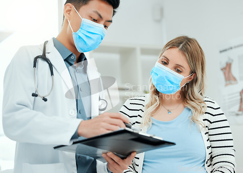 Image of Healthcare, woman and doctor with a clipboard, consultation and conversation for diagnosis. Female person, patient or medical professional with a document, explain insurance or symptoms in a hospital