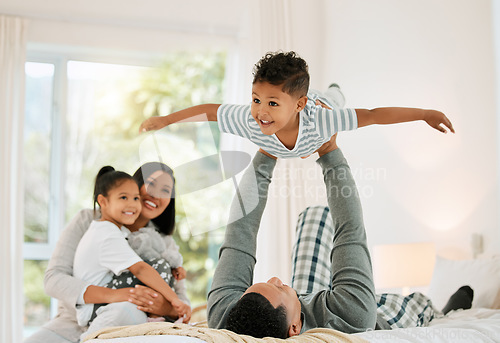 Image of Airplane, family and father with boy, bed and happiness with bonding, loving together and laughing. Love, parents and siblings in a bedroom, brother and sister playing games, fun and weekend break