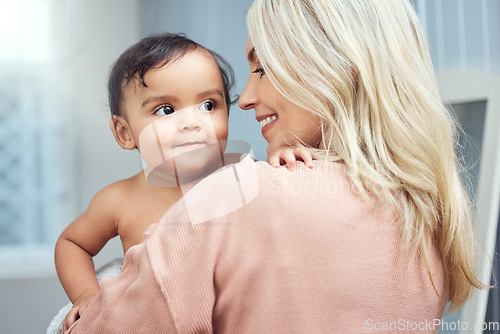 Image of Happy, love and mother bonding with her baby in the nursery room of their modern family home. Happiness, smile and young woman holding a cute girl infant child with care and affection in their house.