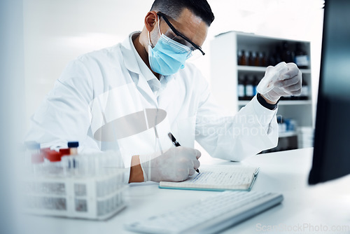 Image of Science, research and scientist writing notes while doing a data analysis in a medical laboratory. Healthcare, notebook and male researcher working on a scientific project at a pharmaceutical lab.