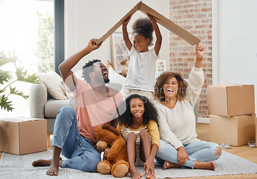 Image of Black family, floor and cardboard roof in home living room with game, laughing and bond with love. Father, mother and daughter with play, relax of box for sign of security in family house with smile