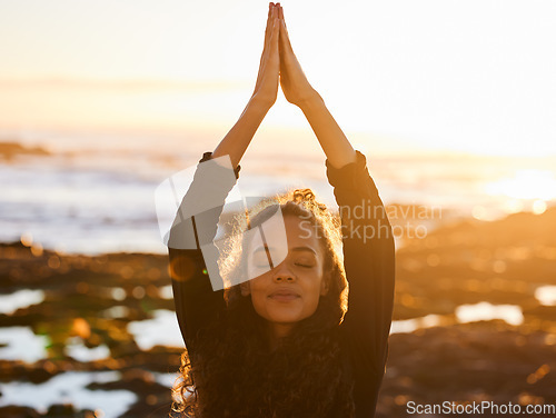 Image of Woman, beach yoga and sunset with pray hands, eyes closed and peace of mind in summer sunshine. Girl, zen meditation and mindfulness for health, wellness and exercise by ocean with stretching outdoor