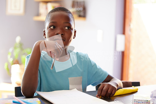 Image of Education, thinking and boy child doing homework with his knowledge notebook in the living room. School, paper and African kid student studying for test, project or exam with concentration at home.