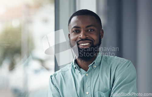 Image of African business man, portrait and smile by window with happiness, pride and entrepreneurship at startup. Black businessman, face and happy manager at company, success and confidence in finance job